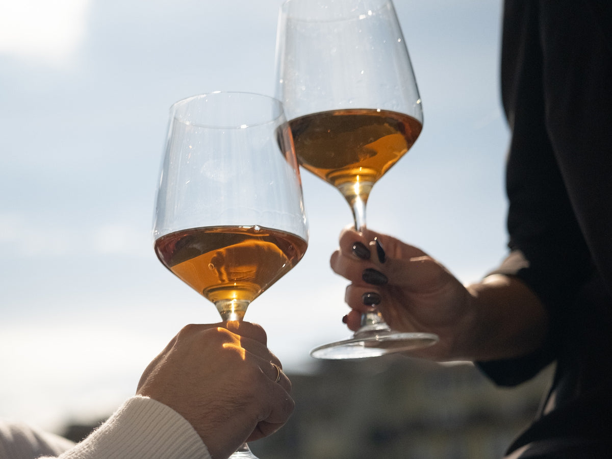Two glasses of Vin Santo raised in a toast in the Florence sun: the Guest Aperitivo at The Atelier 1971