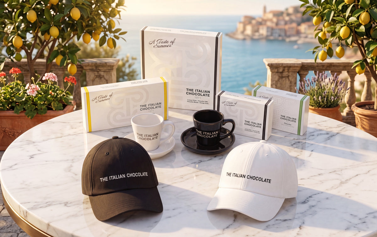 A Taste of Summer boxes on a marble table under lemon trees, with the sea behind